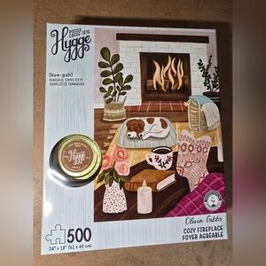 Hygge Cozy Fireplace 500-Piece Puzzle with new candle.